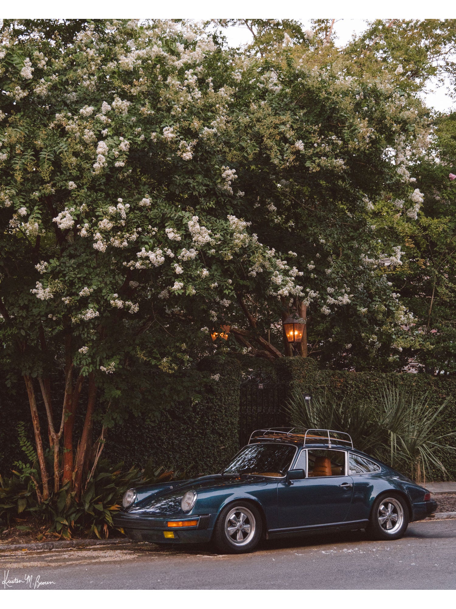 Tucked beneath the cascading white blooms of a towering crepe myrtle, this vintage Porsche 911 awaits its next adventure. So what are you waiting for? Hop on in and channel that carefree feeling of adventure and speed with this air cooled vintage beauty, "911 Meeting". Vintage Porsche 911 photo print by Kristen M. Brown of Samba to the Sea for The Sunset Shop.