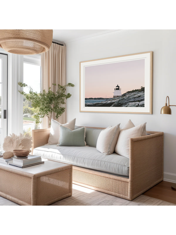 "Castle Hill en Rosé" photo print of the Castle Hill lighthouse in Newport, Rhode Island with a dreamy pastel pink sunrise sky and the Clairborne Pell Newport Bridge in the background hanging in a serene coastal living room. Photographed by Kristen M. Brown of Samba to the Sea for The Sunset Shop.