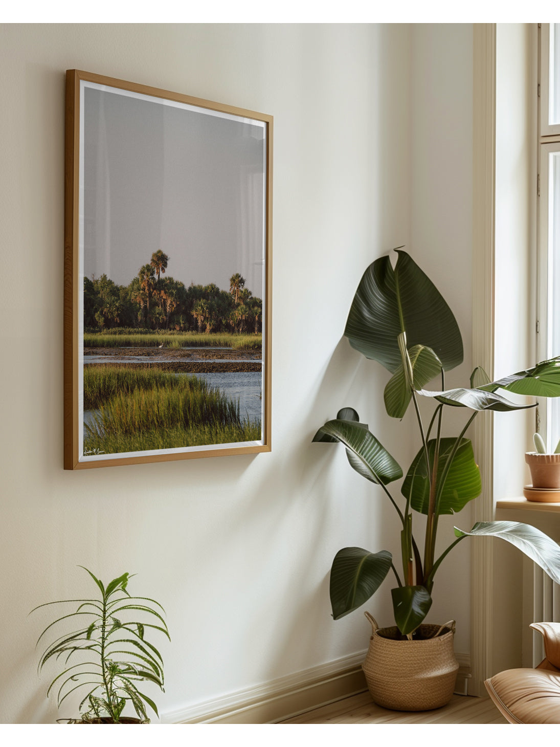 In the heart of the Lowcountry marsh, amongst a dense hammock of palmettos catching the soft, sun-dappled early morning glow, the tide recedes to reveal a quiet, untouched world where native wildlife rules the shore. "Heron Island" framed photograph of a graceful white egret heron in the shallow tidal flats, framed by exposed oyster beds and lush, golden-green marsh grass. Photo print by Kristen M. Brown of Samba to the Sea for The Sunset Shop.
