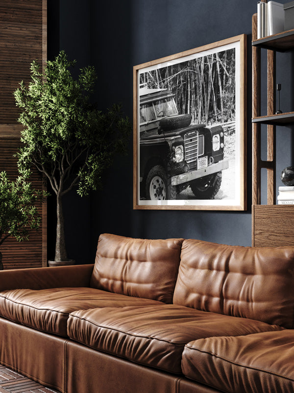 Vintage Land Rover black and white wall art in man cave library with dark walls and leather couch. Vintage car art by Kristen M. Brown of Samba to the Sea for The Sunset Shop.
