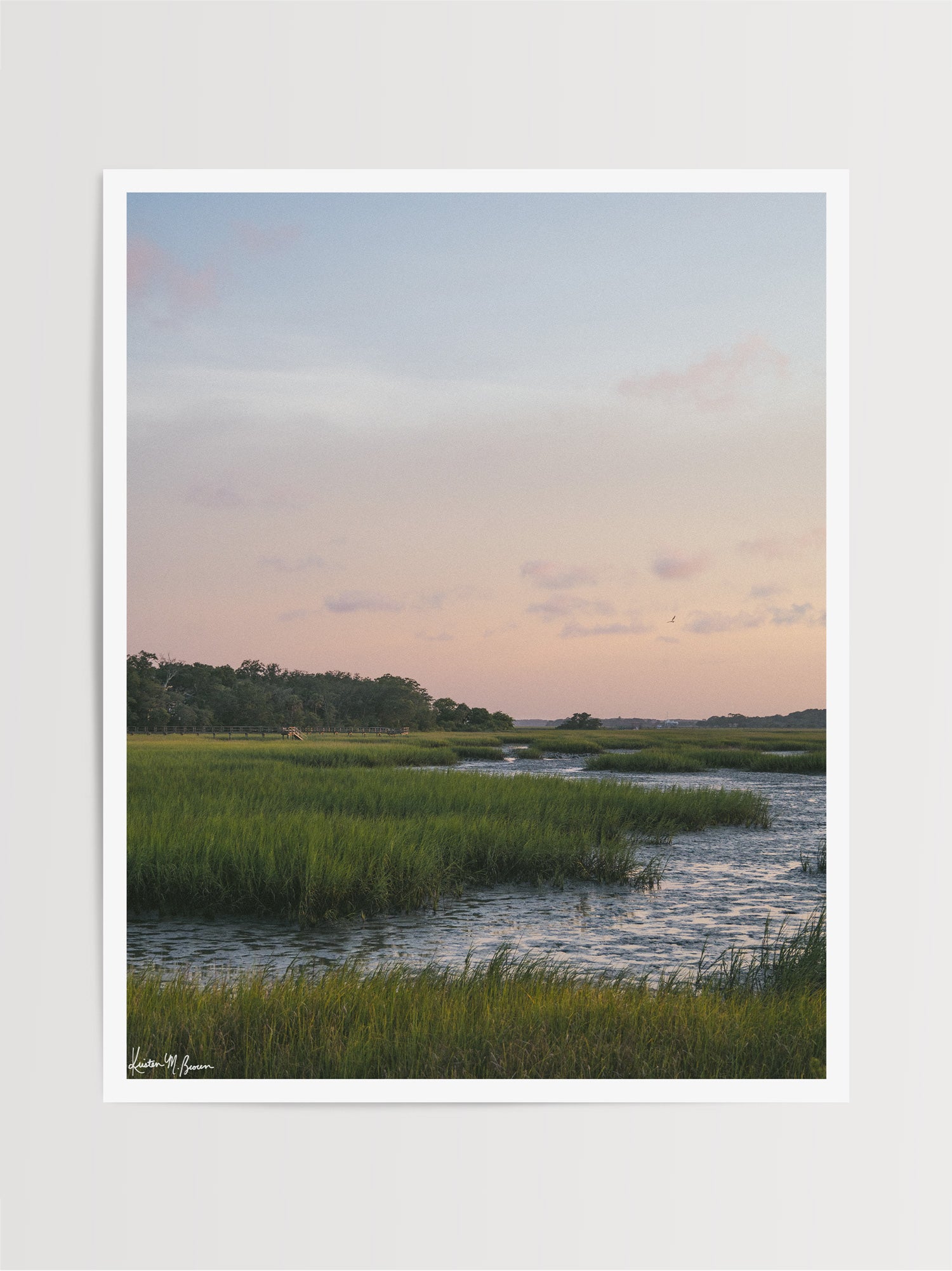 Scenic landscape photograph of pastel sunset over the low tide marsh. When the day settles into twilight, the marsh softens into a painterly blend of pastel skies, swaying marsh grass, and the gentle ebb of the tide. Photo print by Kristen M. Brown of Samba to the Sea for The Sunset Shop.