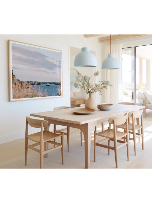 "Seaclusion" photo print of wood motorboat moored along Ocean Drive in Newport, RI framed print hanging in serene coastal dining room. Photographed by Kristen M. Brown of Samba to the Sea for The Sunset Shop.