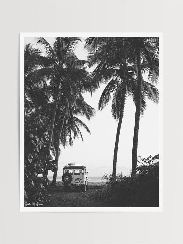 Down a hidden dirt road lies a dreamy, peeling wave that only you and your surf amigo/a know about. A perfect point break made for two. You hear a new swell is on the way, so you hop in your vintage Land Cruiser, pick up your buddy, and surf the day away with no one else out. Welcome back to your surf dream, all from the comfort of your home...wherever home may be. šš“š "Secret Spot" black and white palm tree + surfboard photo print in Costa Rica by Kristen M. Brown of Samba to the Sea for The Sunset Shop