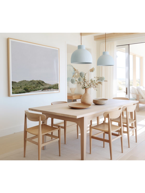 "The Coast is Calling" photo print of beach dunes in coastal New England on a gray, overcast day framed print hanging in serene coastal dining room. Photographed by Kristen M. Brown of Samba to the Sea for The Sunset Shop.