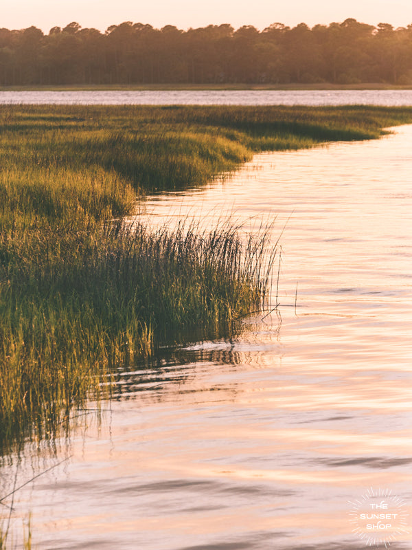 Take a deep breath and say thank you to a beautiful day with a serene sunset sky over the marsh in Savannah, GA. "Marsh en Rosé" photographed by Kristen M. Brown, Samba to the Sea for The Sunset Shop.