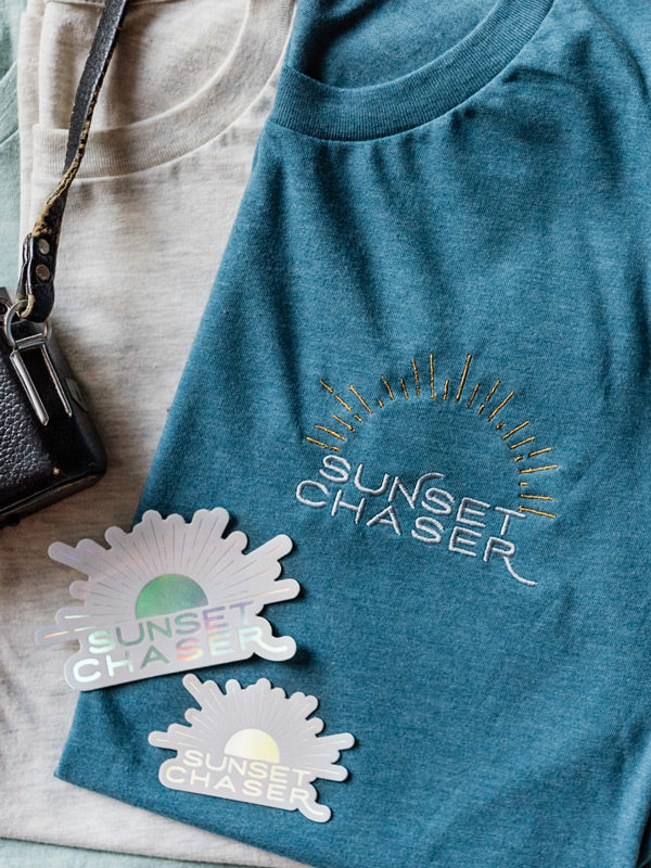 Calling all sunset chasers! There's nothing like ending the day watching the sun pass over horizon, painting the sky in magical colors...and now you can chase sunset while rocking this super comfy, relaxed Sunset Chaser tee! Embroidered with silver and gold thread, you won't want to take this tee off — it's that stylish AND comfortable!!! Click here to check this tee out! Available at The Sunset Shop by Kristen M. Brown, Samba to the Sea.