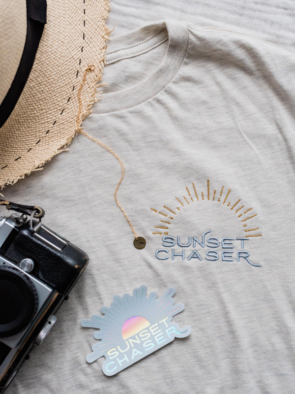 Calling all sunset chasers! There's nothing like ending the day watching the sun pass over horizon, painting the sky in magical colors...and now you can chase sunset while rocking this super comfy, relaxed Sunset Chaser tee! Embroidered with silver and gold thread, you won't want to take this tee off — it's that stylish AND comfortable!!! Click here to check this tee out! Available at The Sunset Shop by Kristen M. Brown, Samba to the Sea.