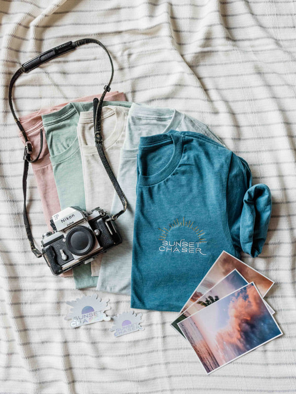 Calling all sunset chasers! There's nothing like ending the day watching the sun pass over horizon, painting the sky in magical colors...and now you can chase sunset while rocking this super comfy, relaxed Sunset Chaser tee! Embroidered with silver and gold thread, you won't want to take this tee off — it's that stylish AND comfortable!!! Click here to check this tee out! Available at The Sunset Shop by Kristen M. Brown, Samba to the Sea. #sunsetchaser