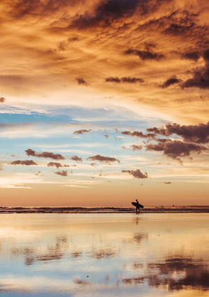 Surfer walking on the beach during a beautiful sunset in Costa Rica. Sunset surfer print by Samba to the Sea at The Sunset Shop.