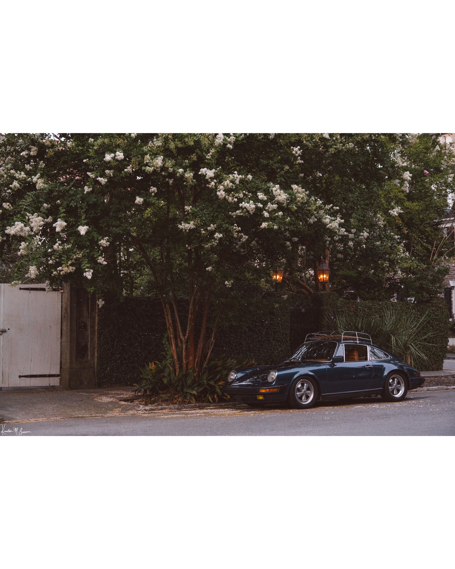 Tucked beneath the cascading white blooms of a towering crepe myrtle, this vintage Porsche 911 awaits its next adventure. So what are you waiting for? Hop on in and channel that carefree feeling of adventure and speed with this air cooled vintage beauty, "911 Meeting".  Vintage Porsche 911 photo print by Kristen M. Brown of Samba to the Sea for The Sunset Shop.