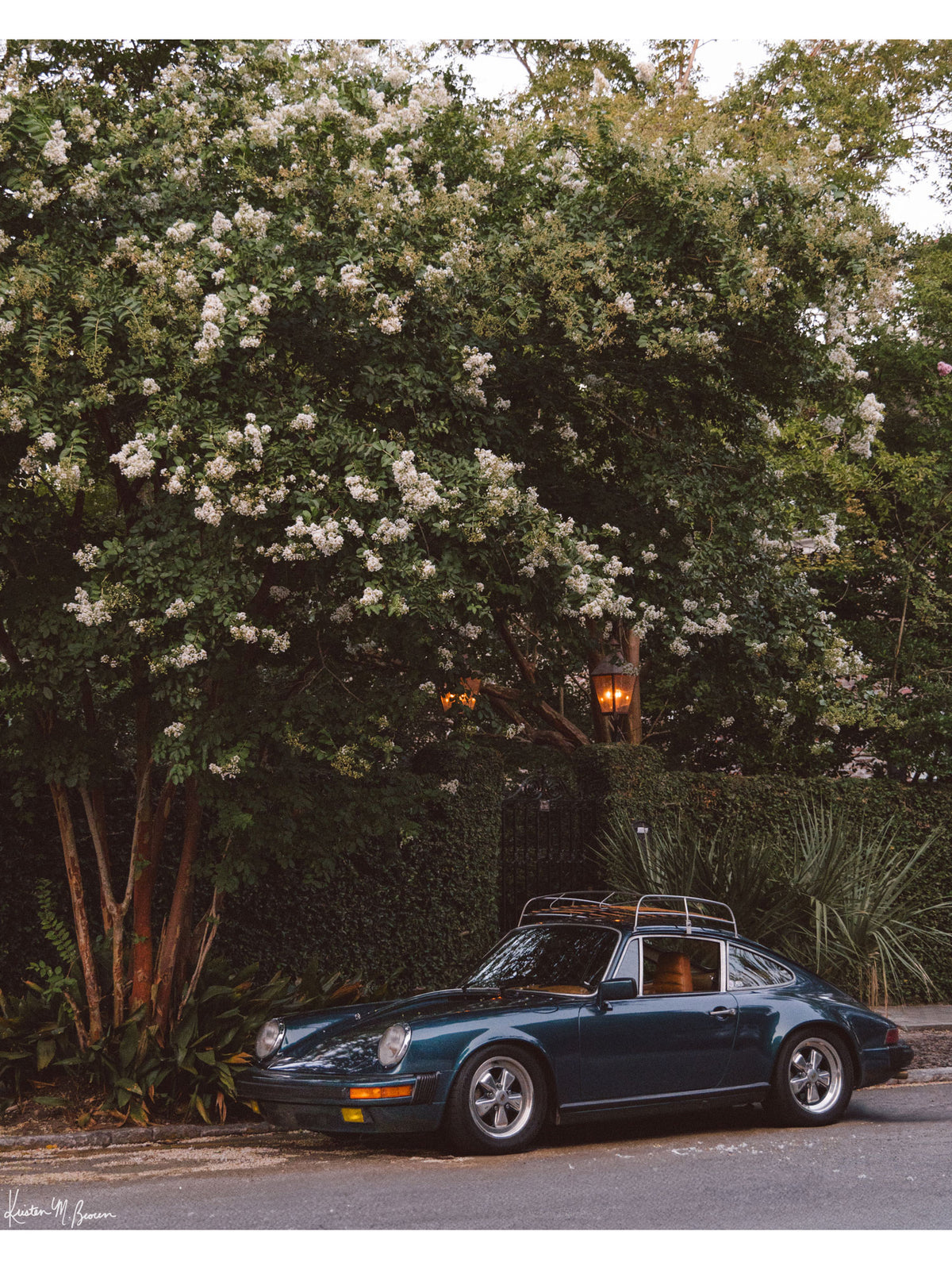 Tucked beneath the cascading white blooms of a towering crepe myrtle, this vintage Porsche 911 awaits its next adventure. So what are you waiting for? Hop on in and channel that carefree feeling of adventure and speed with this air cooled vintage beauty, "911 Meeting".  Vintage Porsche 911 photo print by Kristen M. Brown of Samba to the Sea for The Sunset Shop.
