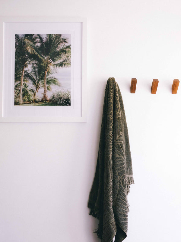 Palm tree photo print hanging in bathroom. Palm trees at beach path entrance in Costa Rica. Palm tree beach print at The Sunset Shop by Samba to the Sea. Interior by Dani of Goldcoast Canvas.