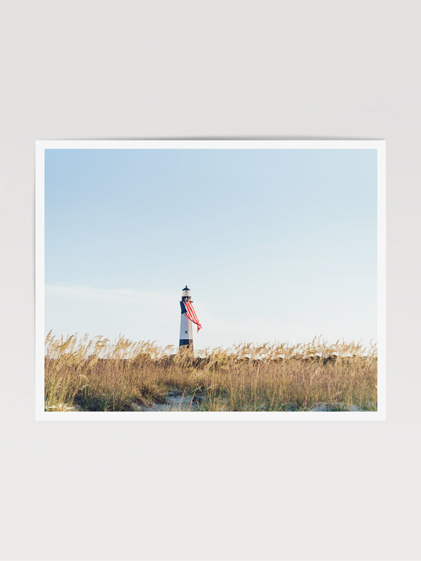 There she was, dancing in the sea breeze with the sea grass and shimmering in the late afternoon sun! Majestic American flag hanging from the Tybee Island Lighthouse in Tybee Island, GA. "Amber Waves" photographed by Kristen M. Brown, Samba to the Sea for The Sunset Shop.