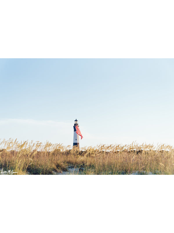 There she was, dancing in the sea breeze with the sea grass and shimmering in the late afternoon sun! Majestic American flag hanging from the Tybee Island Lighthouse in Tybee Island, GA. &quot;Amber Waves&quot; photographed by Kristen M. Brown, Samba to the Sea for The Sunset Shop.