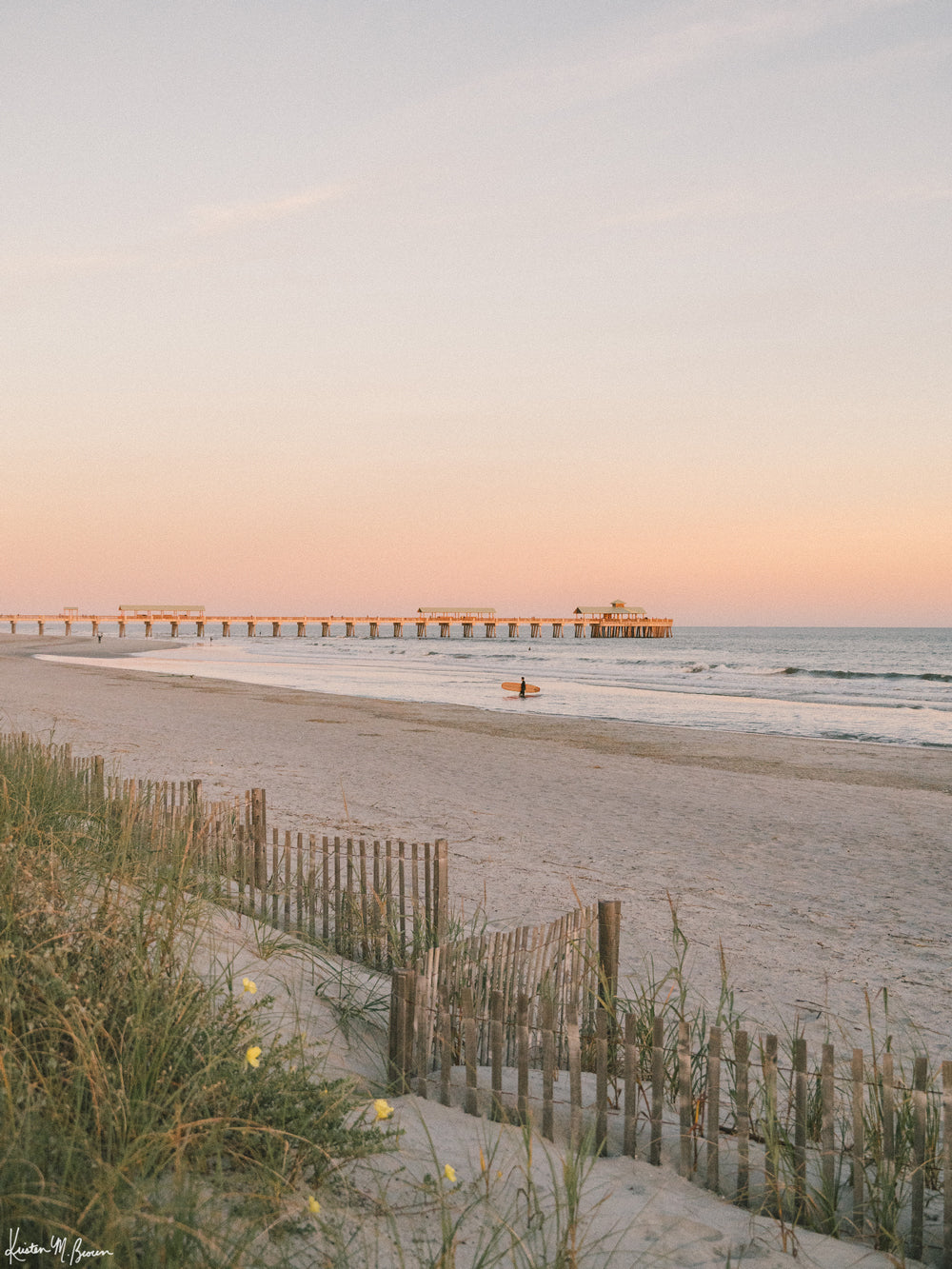 Photography of surfer walking out ocean at sunset in Charleston at Folly Beach pier. "Apres Suf" photographed by Kristen M. Brown, Samba to the Sea.