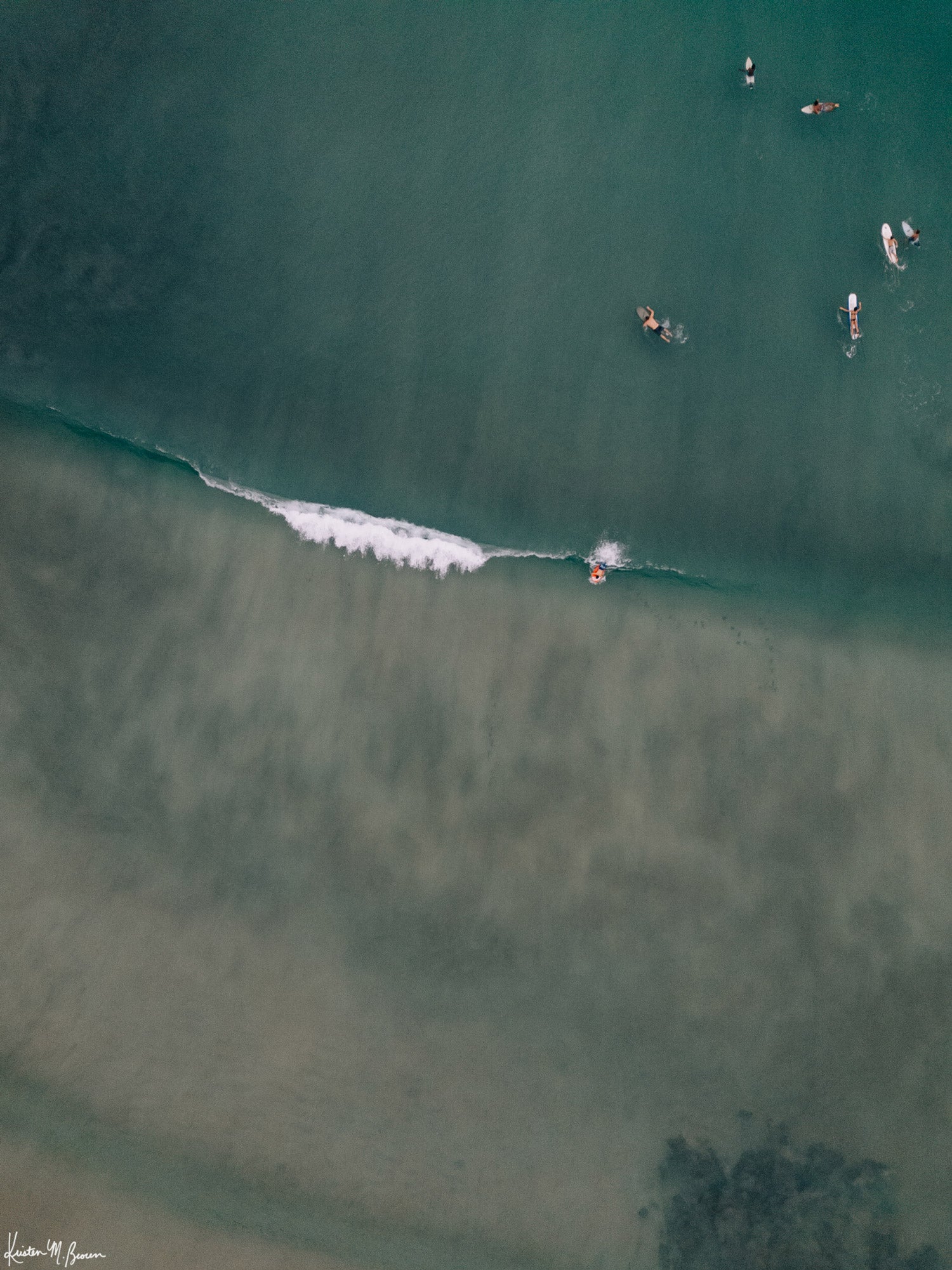 Aerial surfer wave photograph by Samba to the Sea at The Sunset Shop. Image is an aerial photo of surfer dropping in on a wave in Playa Avellanas, Costa Rica.