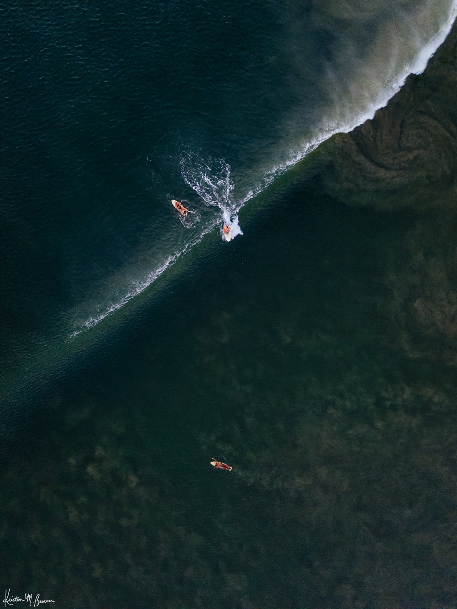 Aerial surfer print by Samba to the Sea at The Sunset Shop. Image is an aerial photo of surfer dropping in on a wave in Tamarindo, Costa Rica.