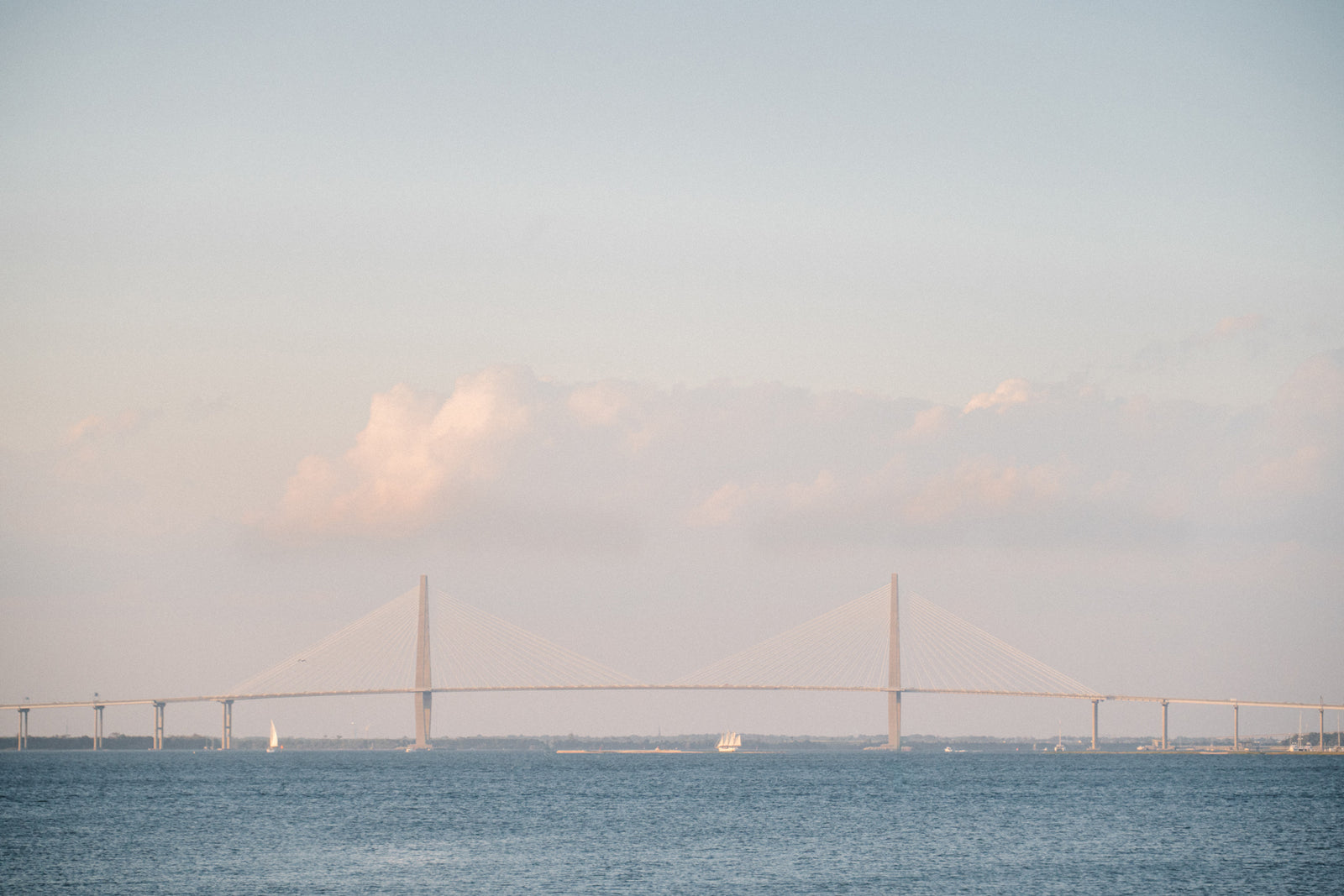 Sailing in Charleston harbor with the Ravenel bridge. Photographed by Kristen M. Brown of Samba to the Sea.