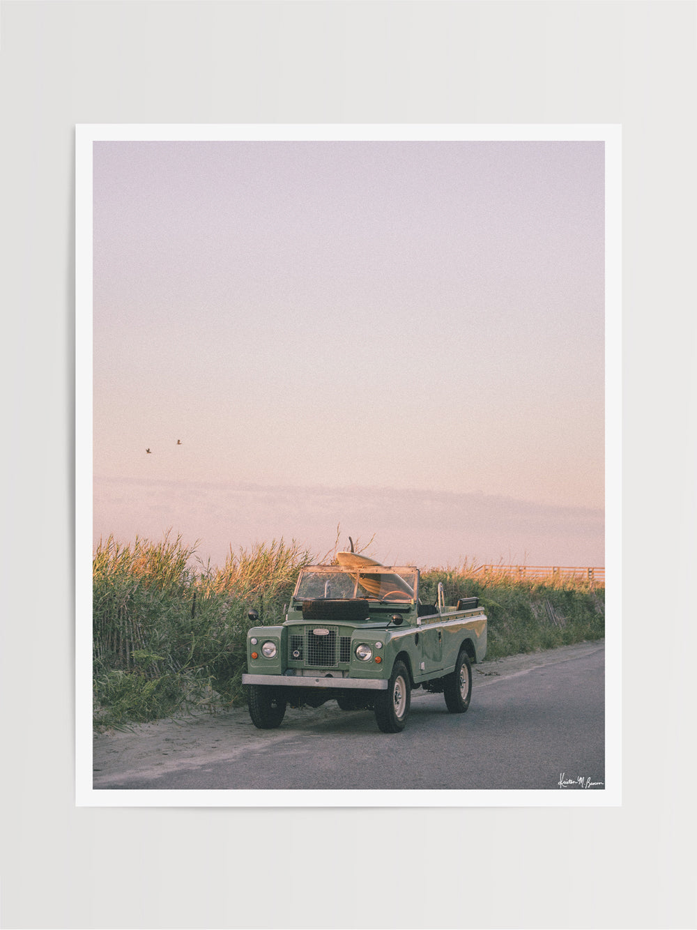 You've been eyeing the surf report all week, waiting for the new swell to arrive. You, your single fin, and your Rover are ready. Arriving at the beach just as the sun is starting to rise, casting its golden glow, you are greeted by glassy, peeling waves. Go on and paddle out! “Follyday Rover" photo print of a single fin surfboard and a Land Rover in Folly Beach, SC. Photographed by Kristen M. Brown of Samba to the Sea.