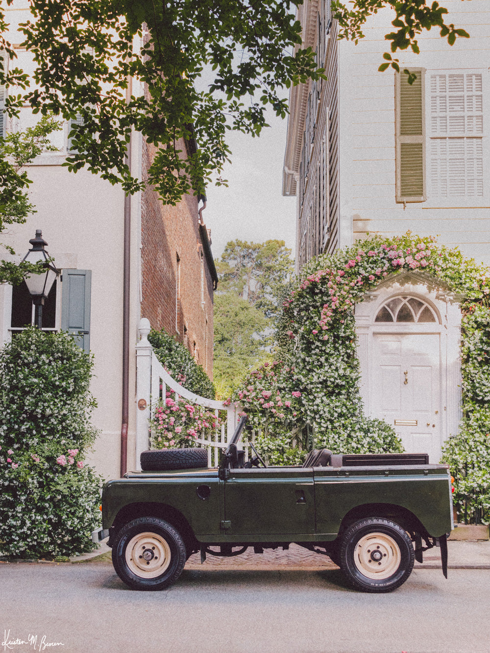 There&#39;s nothing like Charleston in the springtime, especially when the Star Jasmine is in bloom! Hop on in and cruise the intoxicating Jasmine scented streets of Charleston in this beautiful Land Rover Series three truck! &quot;Jasmine Rover&quot; is a journey into the timeless streets of the South, where adventure and nostalgia meet. Photo print by Kristen M. Brown of Samba to the Sea for The Sunset Shop.