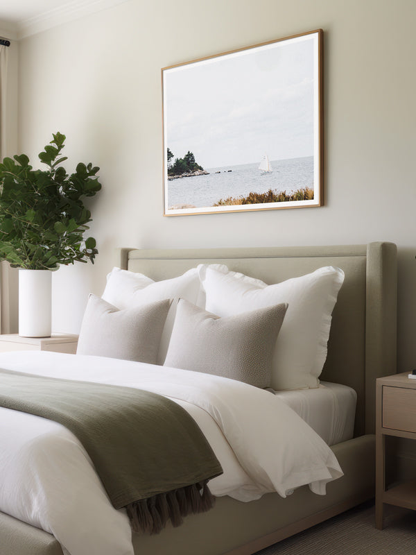 "Just Coasting" photo print of Herreshoff 12 sailing along the New England coast framed print hanging in serene bedroom. Photographed by Kristen M. Brown of Samba to the Sea for The Sunset Shop.