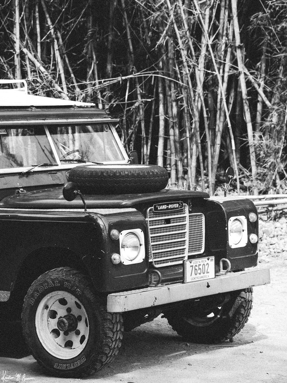 Tucked away in between volcanoes, there lies a magical cloud forest called Monteverde in Costa Rica with a vintage Land Rover series 3 awaiting your arrival. Welcome back to your adventure daydream, all from the comfort of your home...wherever home may be with &quot;Landy Three&quot;. Black and white photo print of Land Rover Series 3 by Kristen M. Brown of Samba to the Sea for The Sunset Shop.