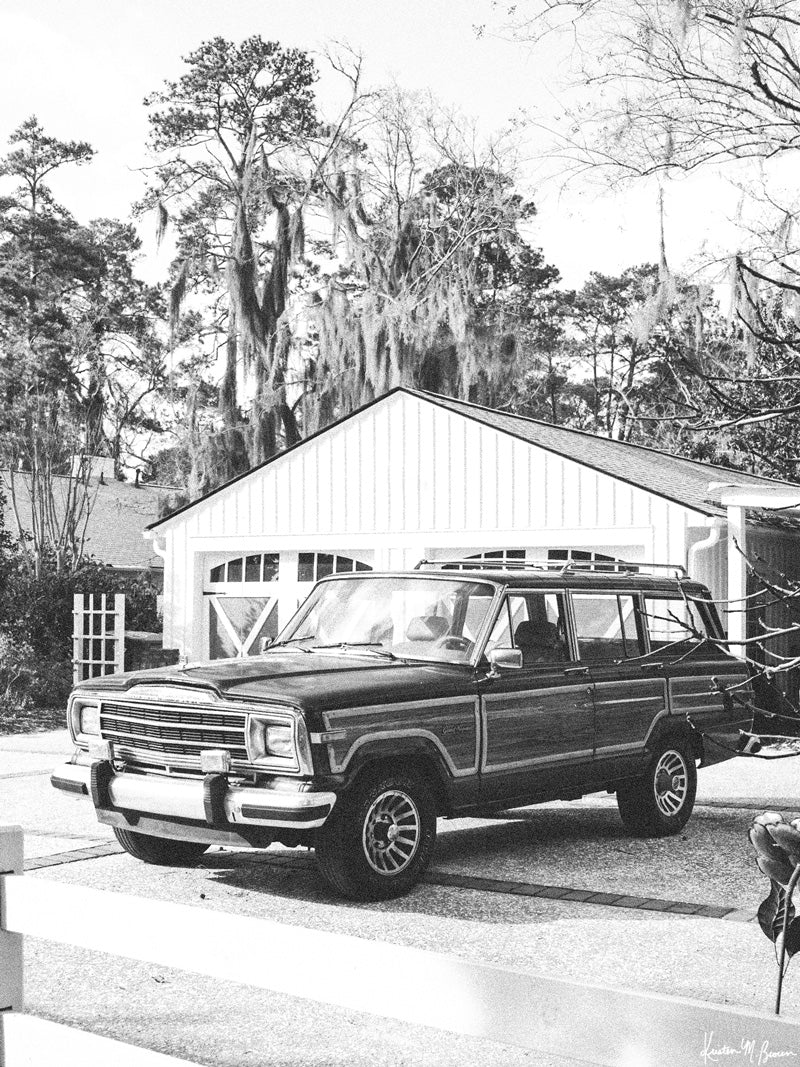 The Jeep that started an entire culture of Jeep lovers -- the Wagoneer! With its timeless design and power, this beauty is an instant transport back to simpler days where you really could easily get off the grid and off road sans cell phones and GPS. Welcome back that amazing family vacation roadtrip, all from the comfort of your smart home...wherever home may be with this B&amp;W photo print "Lowcountry Wagoneer". 
