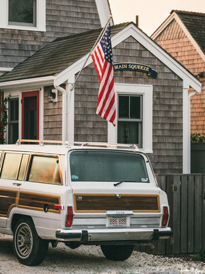 “Main Squeeze Wagoneer“ fine art photo print of classic Jeep Wagoneer parked at a beach house in Cape Cod. Photographed by Kristen M. Brown of Samba to the Sea for The Sunset Shop.