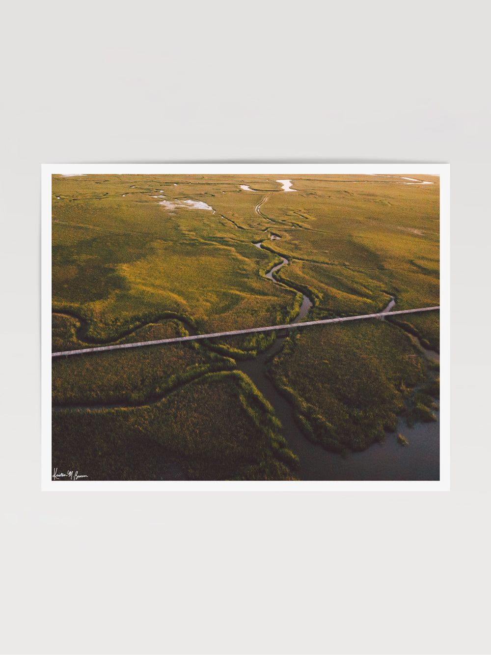 Aerial photograph of boardwalk through the marsh in the early morning sunrise light. "Marsh Walk" photographed by Kristen M. Brown, Samba to the Sea.