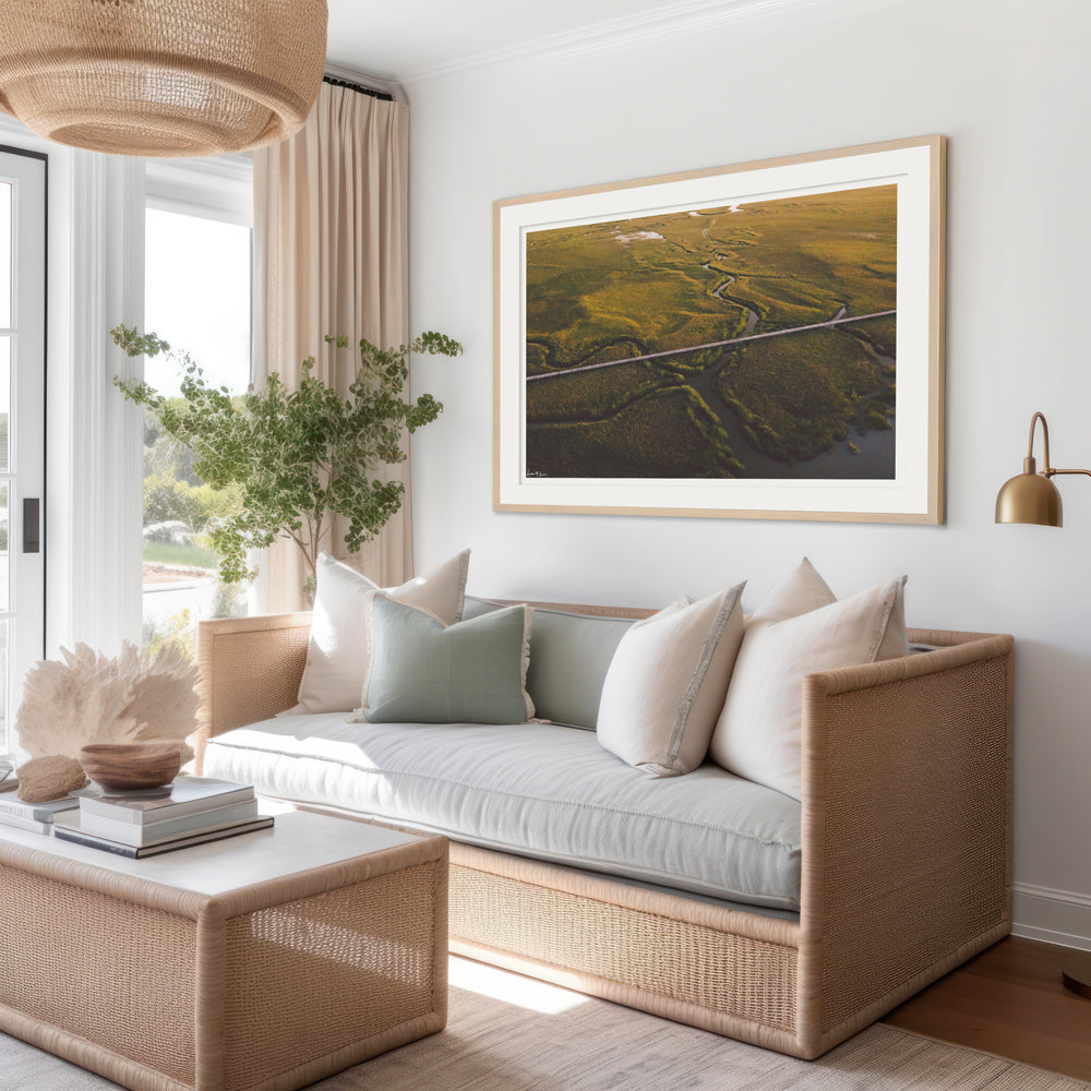 Framed aerial photograph print of boardwalk through the marsh in the early morning sunrise light. Hung in coastal living room. "Marsh Walk" photographed by Kristen M. Brown, Samba to the Sea.