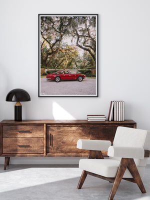 Classic Ferrari photo print hanging in modern living room with beautiful wood furniture. Gorgeous classic Ferrari 365 parked under the Live Oak trees in the Lowcountry of Savannah, Georgia. Photographed by Kristen M. Brown of Samba to the Sea.