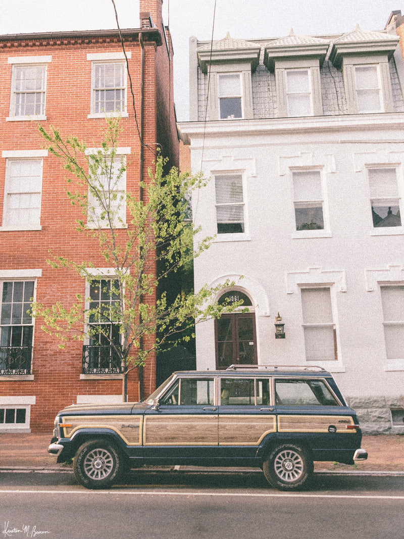 The Jeep that started an entire culture of Jeep lovers -- the Wagoneer! With its timeless design and power, this beauty is an instant transport back to simpler days where you could easily get off the grid...or hop into the city from the &#39;burbs to see the Cherry Blossoms in full bloom in Washington DC! Welcome back to that amazing family weekend city adventure, all from the comfort of your smart home...wherever that smart home may be with this photo print &quot;Old Town Wagoneer&quot;. 