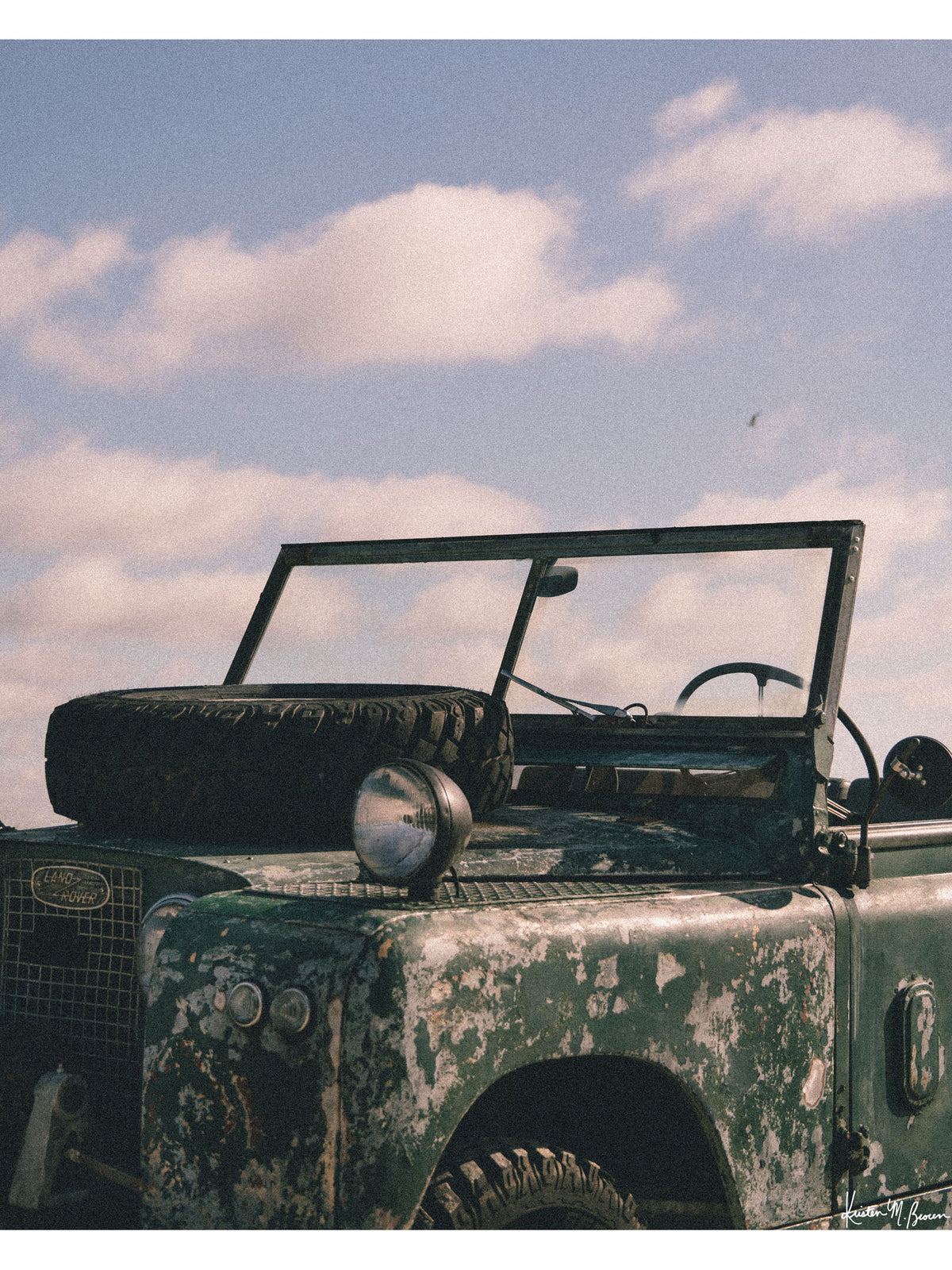 The raw, authentic character of this vintage 1963 Land Rover Series truck, with its iconic hood-mounted spare tire, open-top frame, and soft patina earned through years of adventure, "Patina" embodies the spirit of adventure.  Bring a touch of rugged soul, vintage heritage, and timeless  wanderlust into your space with "Patina", a print that turns rustic wear into pure artistry. Vintage Land Rover photo print by Kristen M. Brown of Samba to the Sea for The Sunset Shop.
