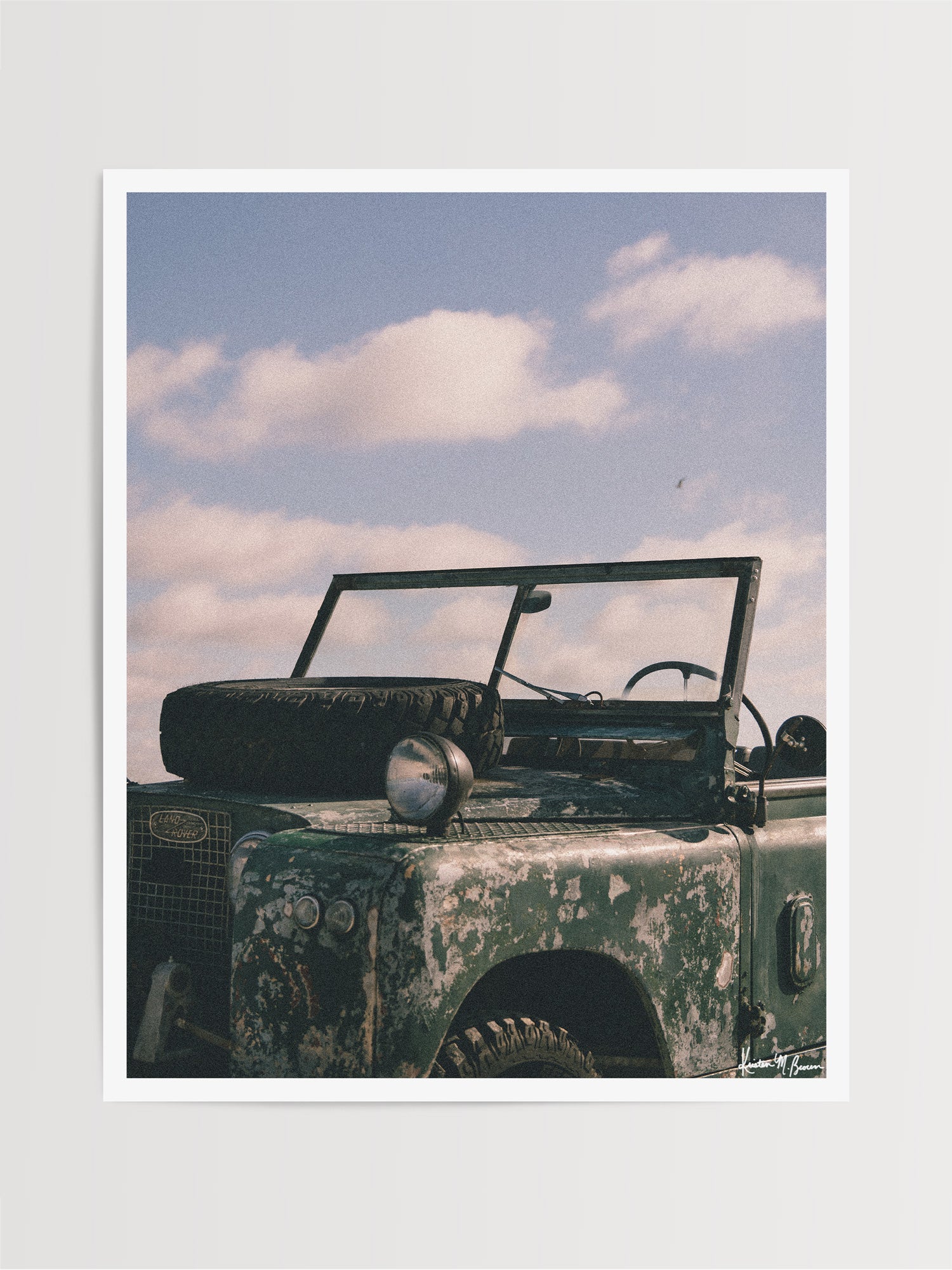The raw, authentic character of this vintage 1963 Land Rover Series truck, with its iconic hood-mounted spare tire, open-top frame, and soft patina earned through years of adventure, "Patina" embodies the spirit of adventure.  Bring a touch of rugged soul, vintage heritage, and timeless  wanderlust into your space with "Patina", a print that turns rustic wear into pure artistry. Vintage Land Rover photo print by Kristen M. Brown of Samba to the Sea for The Sunset Shop.