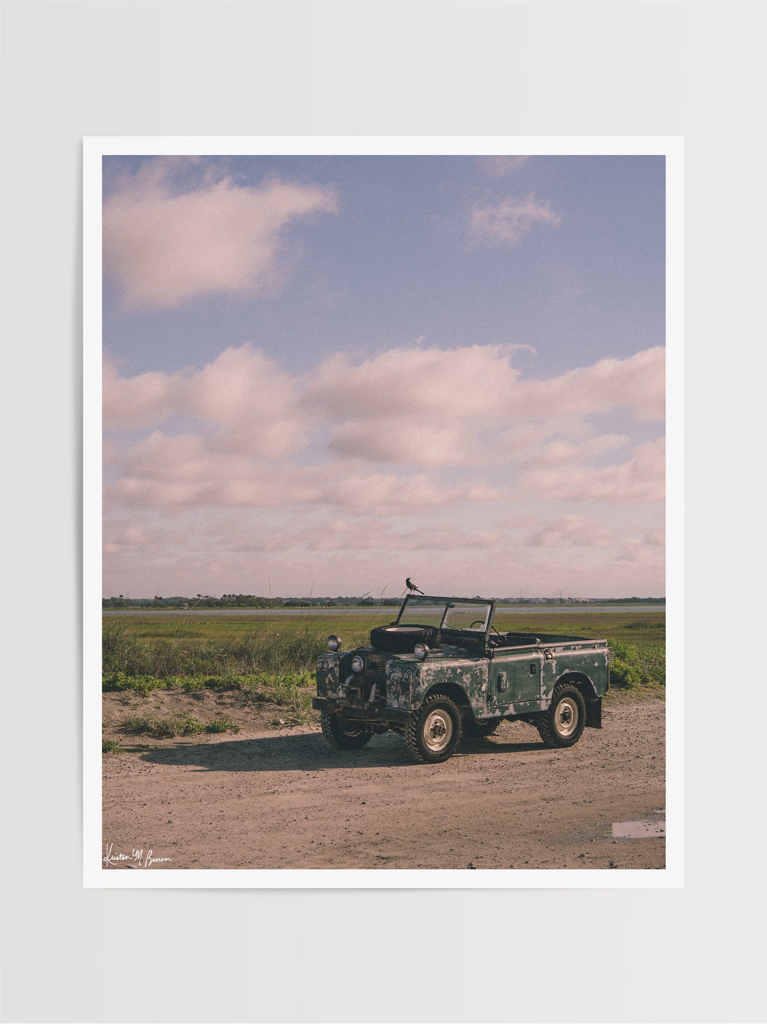 Some stories aren’t written in books - they’re etched in weathered green paint, rusted edges, and decades of sand settled along coastal beach roads. Hop on in to "Perched Patrol" and bring home a piece of adventure with this classic 1963 Land Rover Series IIA truck photo print at the beach in Charleston, SC. Vintage Land Rover photo print by Kristen M. Brown of Samba to the Sea for The Sunset Shop.
