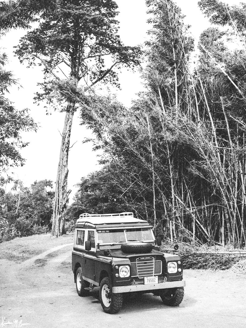 Tucked away in between volcanoes, there lies a magical cloud forest called Monteverde in Costa Rica with a vintage Land Rover series 3 awaiting your arrival. So are you ready? Hop on in and let&#39;s adventure away down dirt mountain roads to find that majestic waterfall you&#39;ve been dreaming of! &quot;Ready to Rover&quot; black and white vintage Land Rover photo print by Kristen M. Brown of Samba to the Sea for The Sunset Shop.