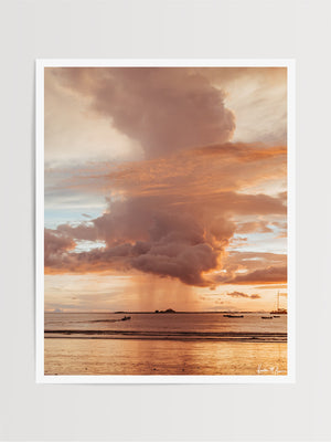 Rose Gold Rain sunset print by Samba to the Sea at The Sunset Shop. Image is a rain shower passing over the horizon during a rose gold sunset in Tamarindo, Costa Rica.