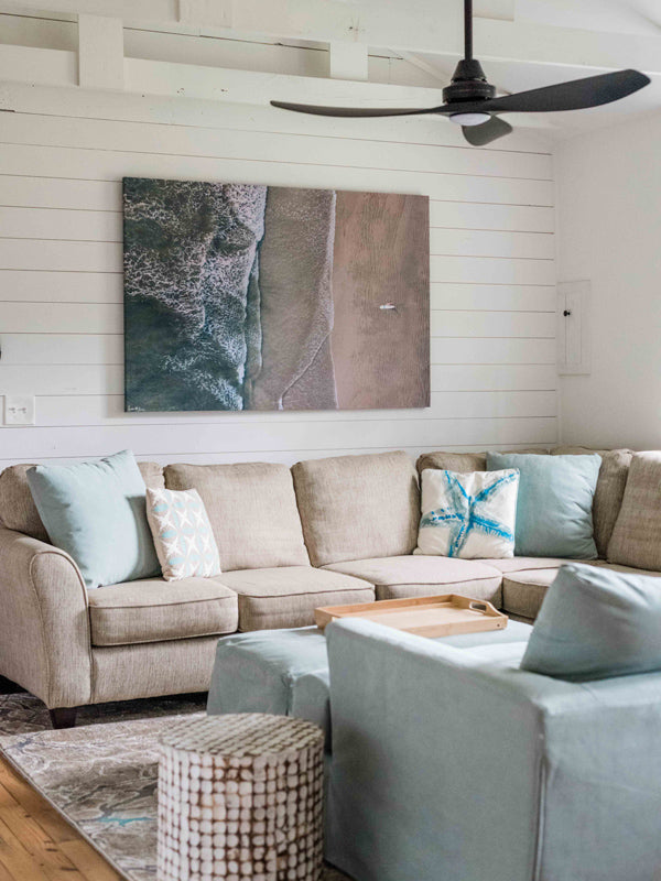 Aerial image of surfer on the beach in Nosara Costa Rica. Salt & Water aerial beach print photographed by Samba to the Sea for The Sunset Shop. Coastal living surfer beach print hanging in Tybee Island beach home..