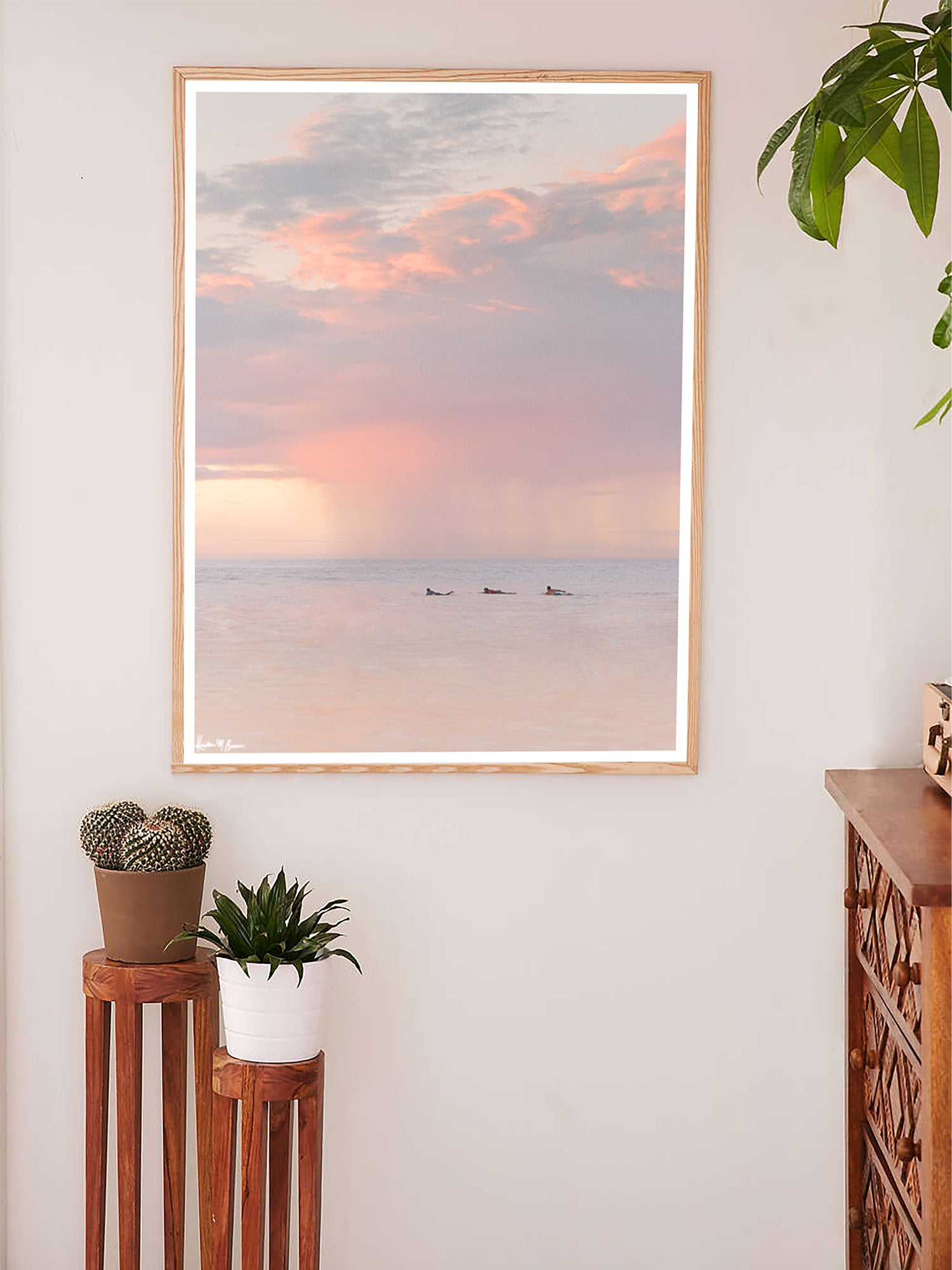 Surfers paddling in the ocean during a pastel pink rain squall at sunset in Costa Rica. What a surfer's dreams are made of - - beautiful sunset surf sessions. Have a piece of sunset surfer magic in your very own home with "Saltwater Paradise" sunset surfer wall art photographed by Kristen M. Brown of Samba to the Sea for The Sunset Shop.