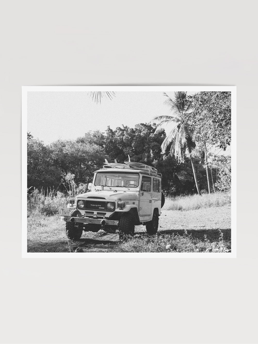 Down a dirt road in Costa Rica lies perfect waves just waiting for you to paddle out --  hop on in to this gorgeous, vintage Toyota Land Cruiser FJ40 and let's roll! "Scenic Route" black and white Land Cruiser photo print of surfboards racked on a vintage Toyota FJ40 photographed by Kristen M. Brown of Samba to the Sea @ The Sunset Shop.