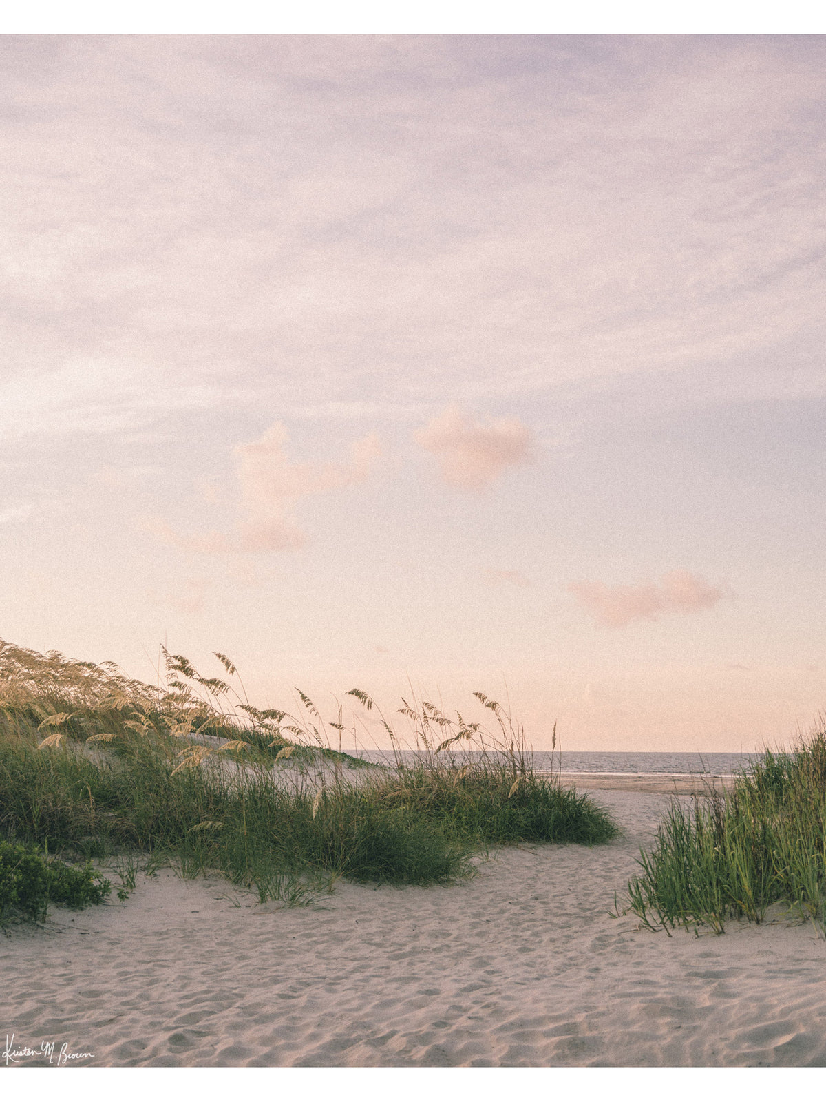 As the morning sun gently ushers in a new day, the coast unfolds in a quiet symphony of soft hues, rustling sea grasses, and an endless horizon. The golden sea oats dance softly in the ocean breeze, inviting you through the beach dunes towards the shoreline. Bring the tranquil rhythm of the ocean and the soothing warmth of a coastal morning into your everyday space with "Sea Oats and Sunrise" photography print.
