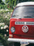 Red VW Bus photo print in Southern California. “Sea Rose Bus” photo print of a beautiful vintage VW Bus parked next to white wea roses in California by Kristen M. Brown of Samba to the Sea for The Sunset Shop. 