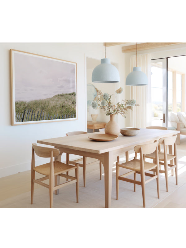 "Seaduced" photo print of rolling beach dunes along the New England coast in Plum Island, MA framed print hanging in serene coastal dining room. Photographed by Kristen M. Brown of Samba to the Sea for The Sunset Shop.