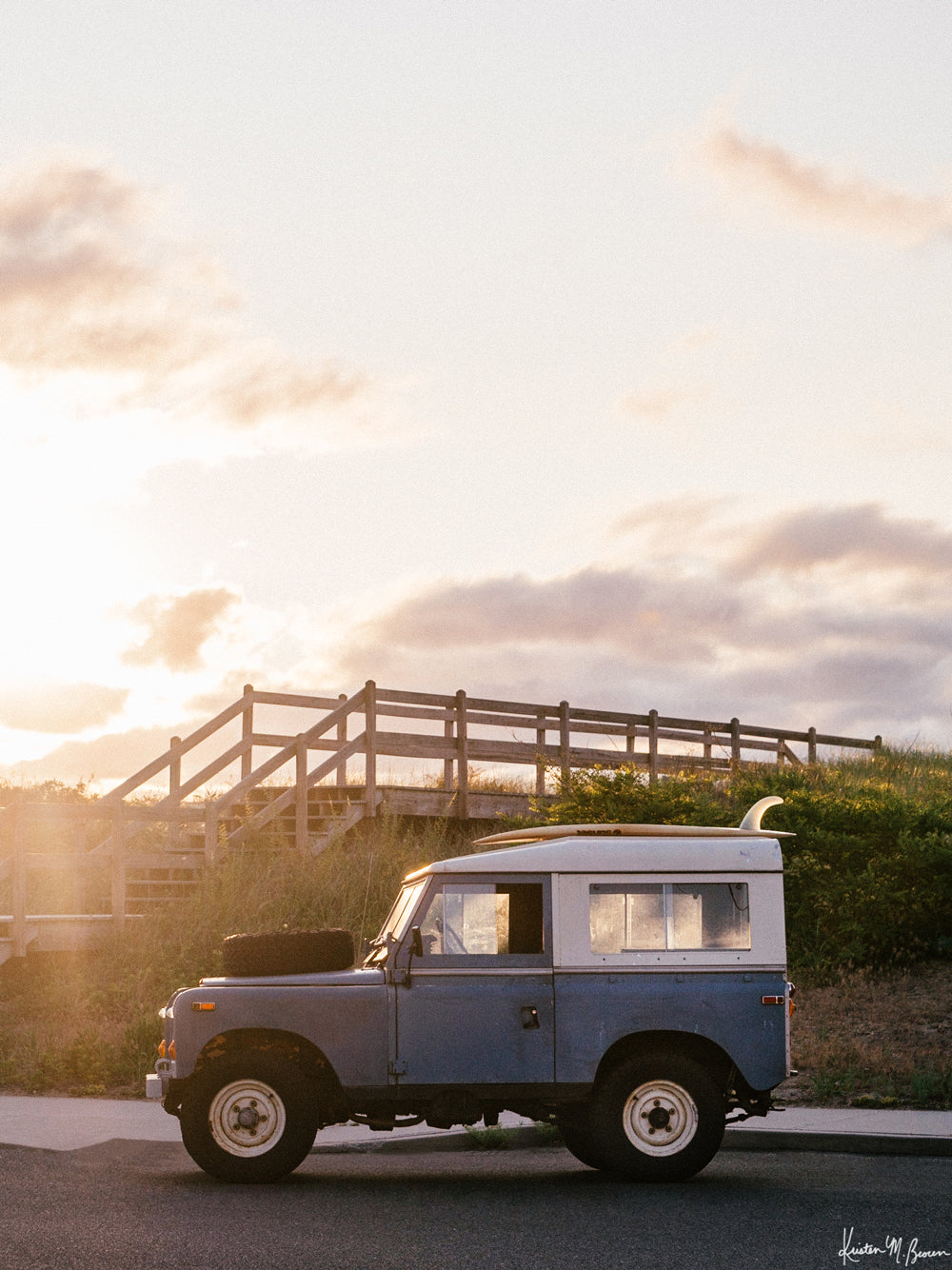 &quot;Shore Rover&quot; photo print of classic Land Rover series three with a single fin surfboard perfectly parked as the sun starts to rise over the Jersey Shore. Photographed by Kristen M. Brown of Samba to the Sea for The Sunset Shop.