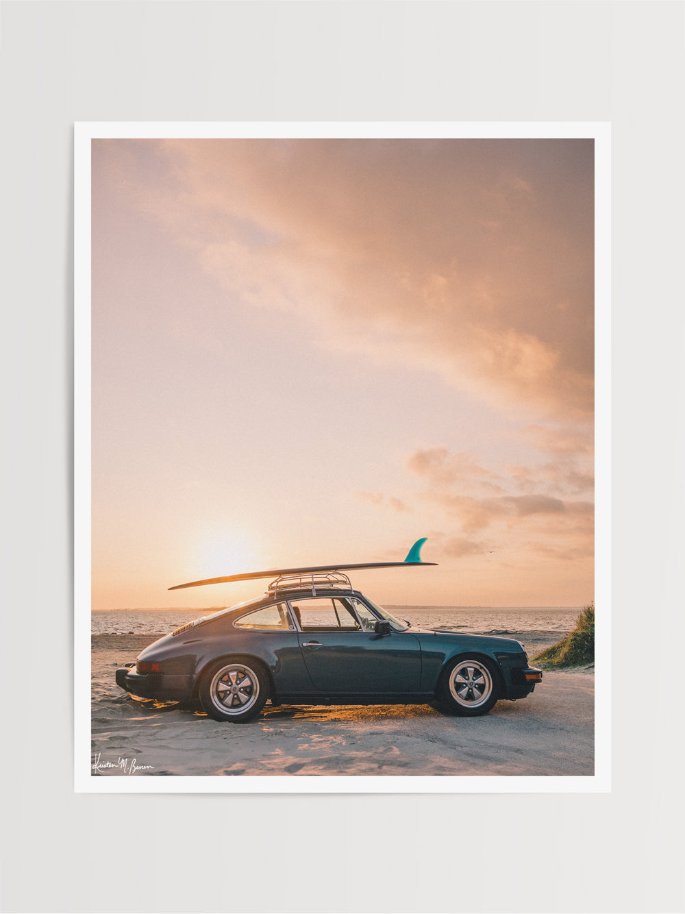 Photograph of vintage Porsche 911 parked at the beach with a classic single fin surfboard amidst a pastel pink sunset sky. "Single Fin Sunset Ride" photographed by Kristen M. Brown, Samba to the Sea.