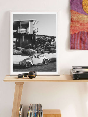 "Stonesteps Bug" black and white photo print of classic VW Bug 1300 perfectly parked at Stonesteps in Encinitas, CA. Photographed by Kristen M. Brown of Samba to the Sea for The Sunset Shop. Vintage VW Bug photo print in midcentury modern living room.