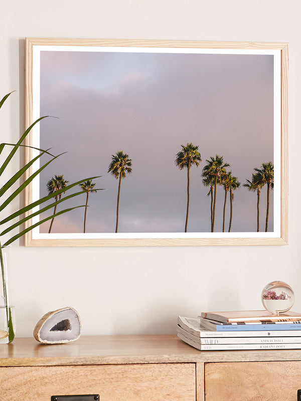 Palm trees sunset sky over Swami’s in Encinitas, California. “Swamis Sunset” palm tree sunset sky photo print by Kristen M. Brown of Samba to the Sea for The Sunset Shop. Southern California palm trees sunset photography wall art in coastal living room.