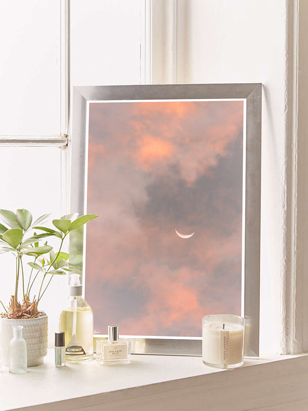 Crescent moon against a cotton candy pink sunrise sky in Savannah Georgia. To the Moon and Back crescent moon print by Samba to the Sea at The Sunset Shop.