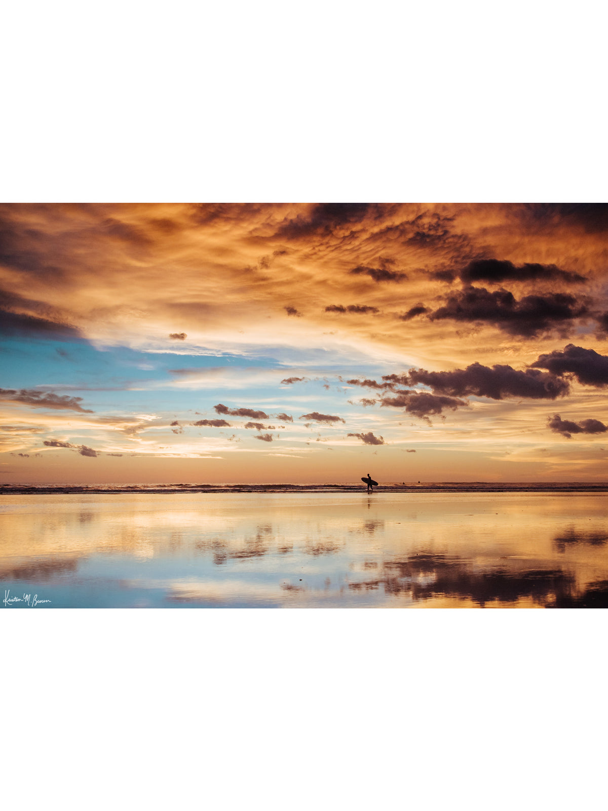 Surfer walking on the beach during a beautiful sunset in Costa Rica. Sunset surfer print by Samba to the Sea at The Sunset Shop.