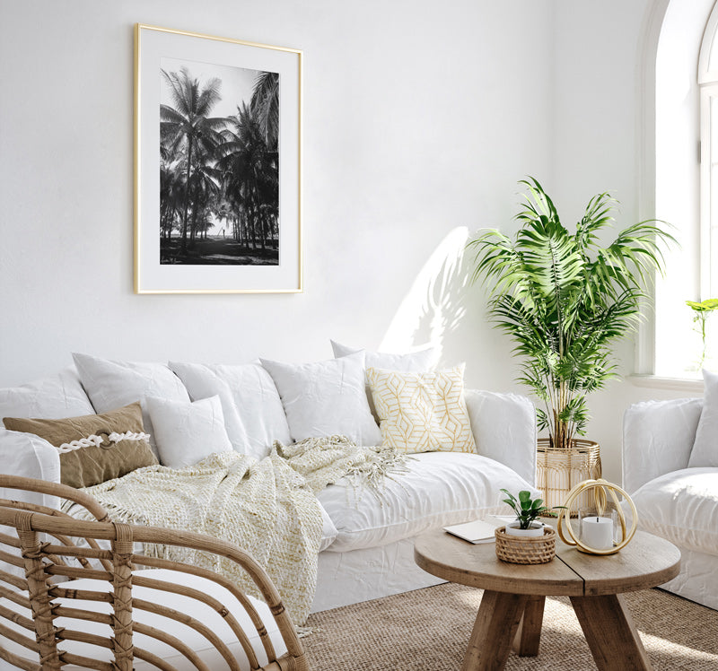 White boho coastal living room with black and white palm tree and surfer girl photography prints. Fine Art Photos by Kristen M. Brown of Samba to the Sea for The Sunset Shop.